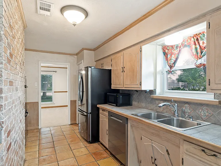 Kitchen flows into front Grand Room.