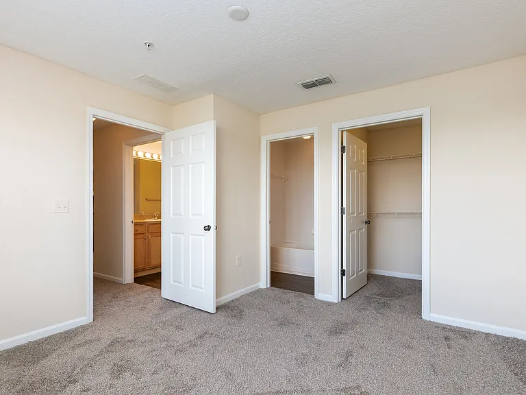 Primary bedroom with ensuite bath and walk-in closet.