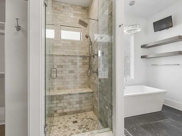 Bathroom #1 is attached to the master bedroom with a dual vanity and stand alone shower + tub. Plus a huge California closet with custom built-ins.