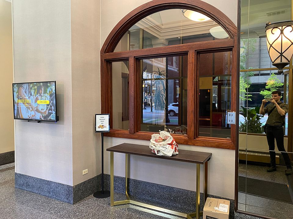 Food delivery station monitored by front desk employees.