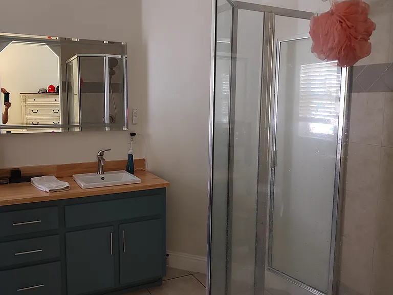 Walk-in shower, upgraded lighting with fan and backlit vanity mirrow