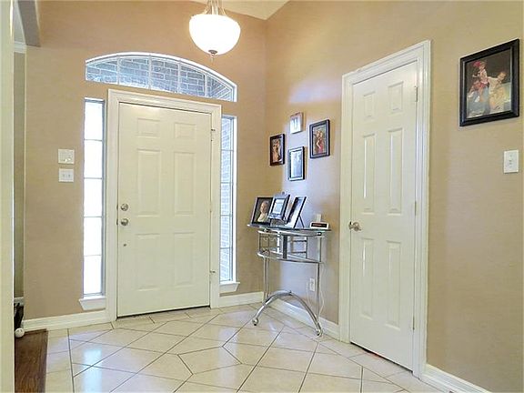 Open foyer with tile a faux transom window.