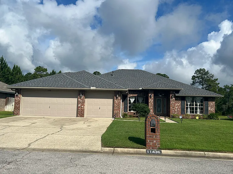 There are only two houses in the entire subdivision with three car garages. Front of house at 11436 Aruba Dr.