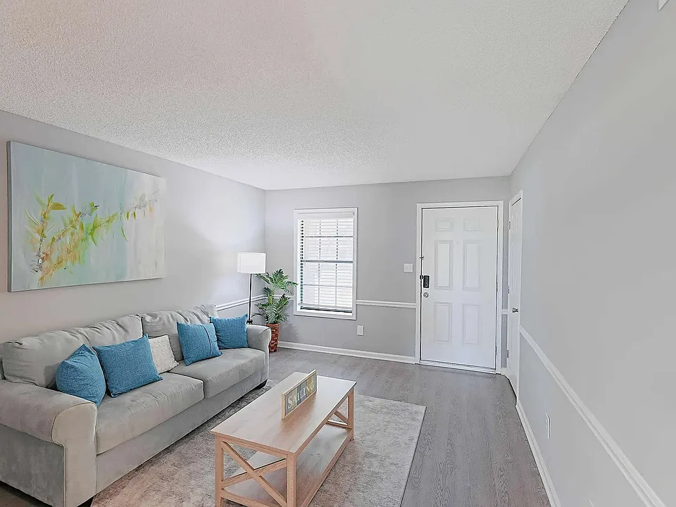 Spacious living room with natural light, modern finishes, and open layout