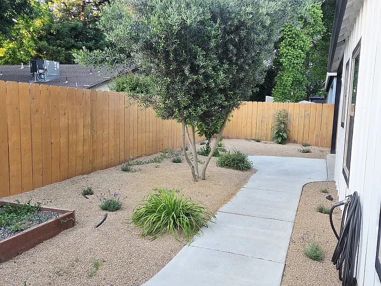 Mediterranean landscape perfect for outdoor living, and garden box for growing your own herbs.