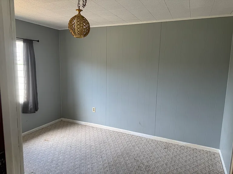 Main floor bedroom off hallway and next to bathroom.