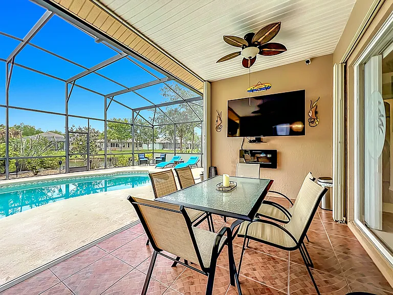Outside Entertaining Area with TV, Electric Fireplace, Table with Chairs