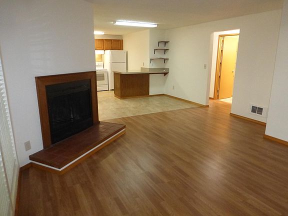 Living room with fireplace for warm cozy times opens to dining and kitchen area.
