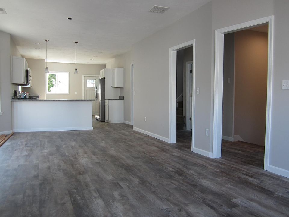 Open floor plan. New flooring, windows, & recessed lighting.