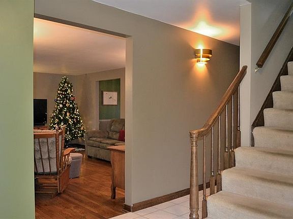 ENTRY.  The large entry opens to the living room, the kitchen, a family room, and den.