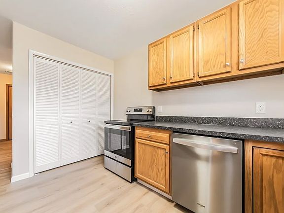 Kitchen view one - 
Washer and dryer are behind doors.
