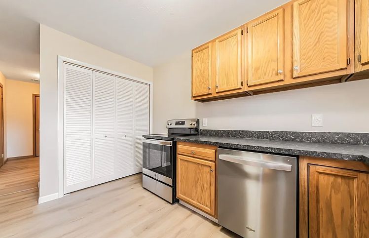 Kitchen view one - 
Washer and dryer are behind doors.