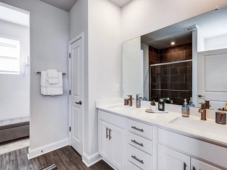 Designer bathrooms with double vanities, quartz countertops and large mirrors.
