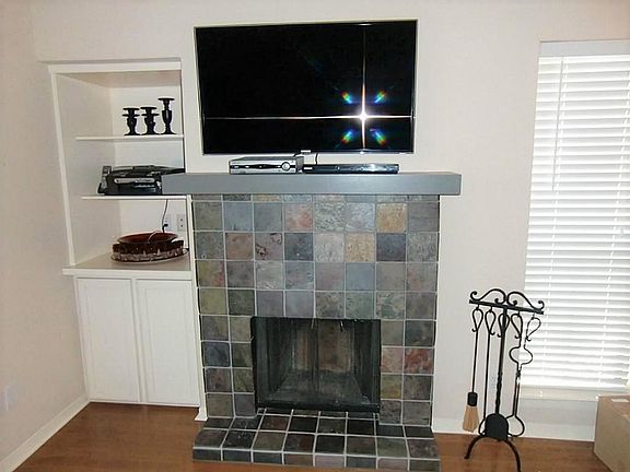 Beautiful slate fireplace makes this room super cozy.  Built in cabinetry beside fireplace with TV hook up above.