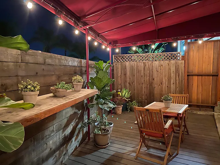Private backyard deck with lighting.