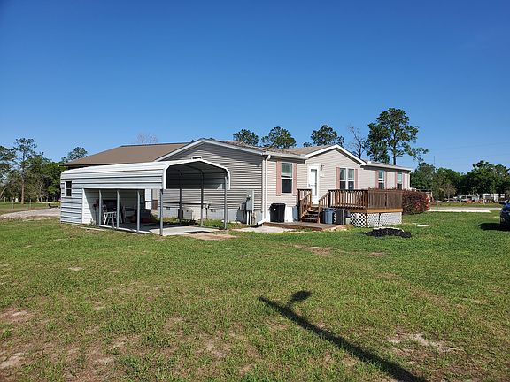 Carport with Storage front view and patio.