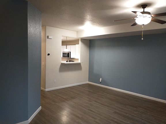 Living room. ceiling fan and breakfast bar