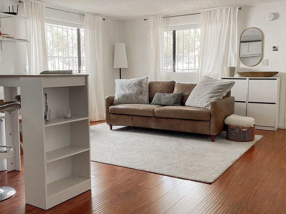 Warm wood toned floors, cleaned daily with self running robot vacuum