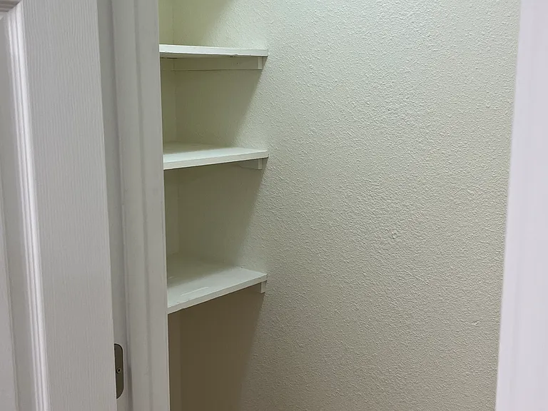 Pantry area with a good amount of space on shelving for food items as well as storage area beneath the shelves and remaining floor area - some tenants have put in an additional shelf unit (not built in)