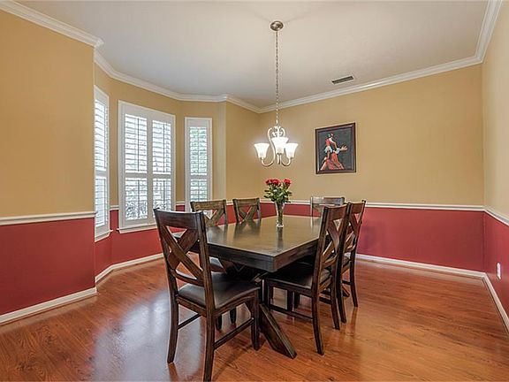 Enjoy family gatherings in this cheerful room with plantation shutters!