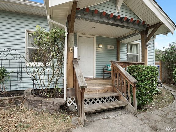 The welcoming front porch is quaint & the seller in the process of painting (white with stained stairs & deck)