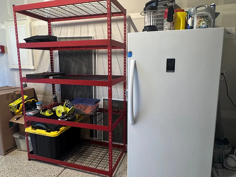 Garage w/ shelving and fridge/freezer combo