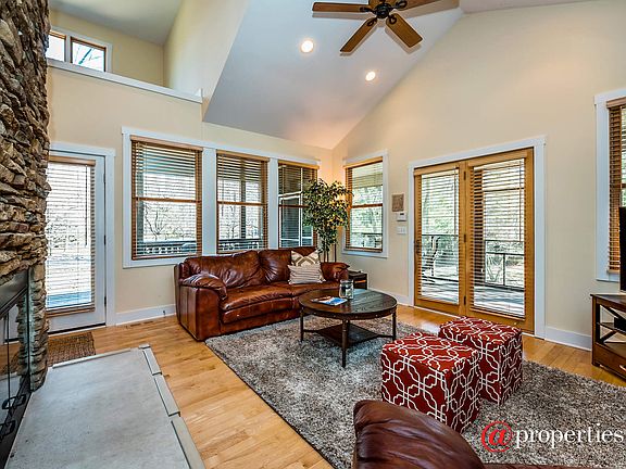 Living room with vaulted ceilings & stone fireplac