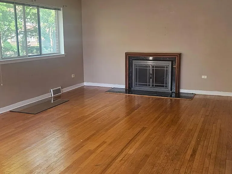 Living Room - (Window - North & Woodburning Fireplace - East)