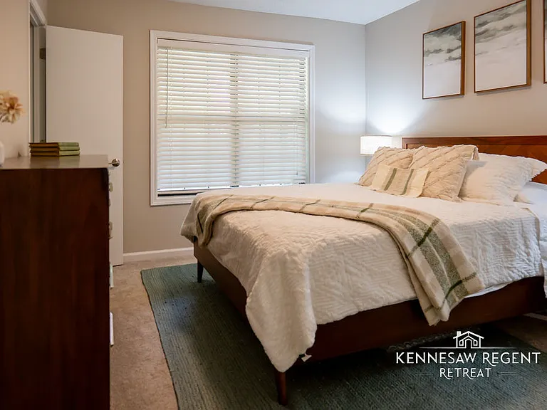 This beautifully designed bedroom is filled with natural light, creating a bright and cheerful atmosphere. A queen-size bed takes center stage, adorned with luxurious linens. A full-size dresser provides ample storage space for clothing and accessories.