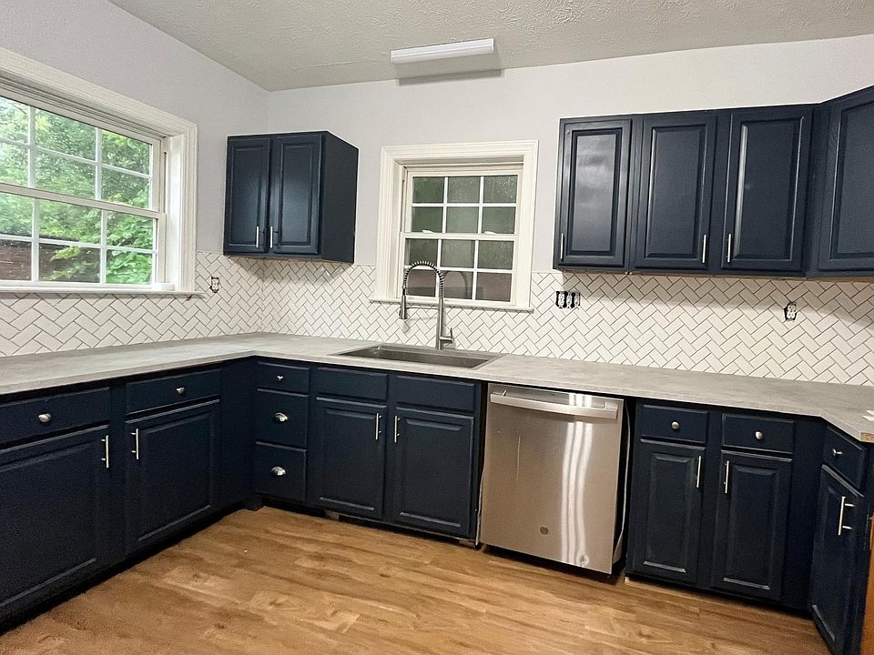 Newly painted kitchen cabinet with TONS of storage space with a new countertop. Newly tiled with a brand new Kohler sink.