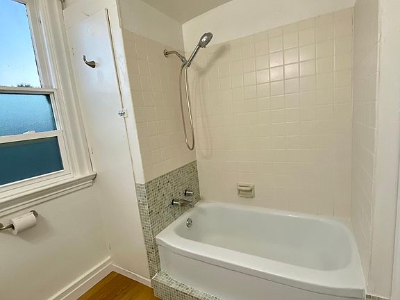 Bathtub with new shower head and faucet fixtures