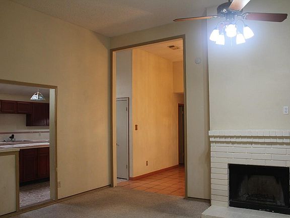 Living room looking into kitchen and hallway to bedrooms