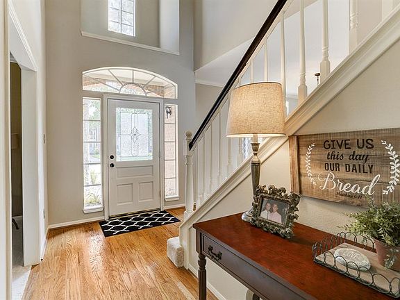 Two story entry with gleaming hardwood flooring and tons of natural light.
