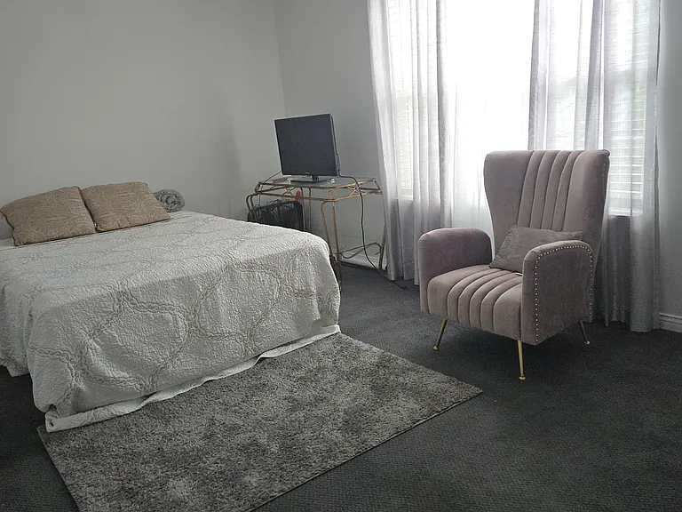Bedroom 3: Queen bed, dresser, walk-in closet, area rug, remote-controlled ceiling fan, curtains, chair