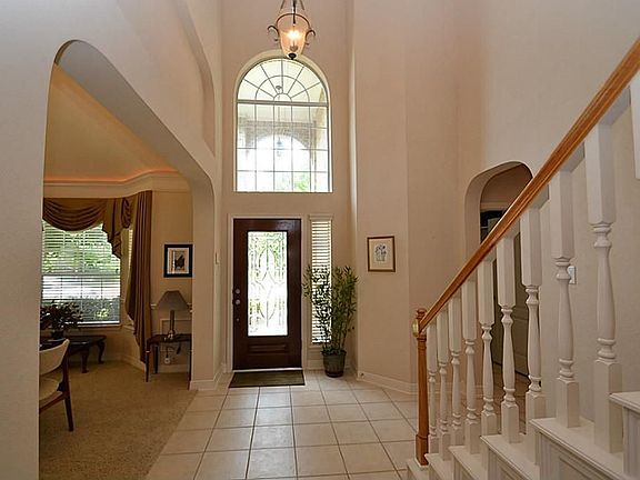 Elegant entry offering two story high ceilings, beveled glass front door and double crown molding.