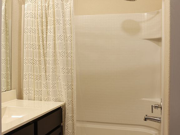 Secondary Bathroom
Rain shower head with curved shower rod