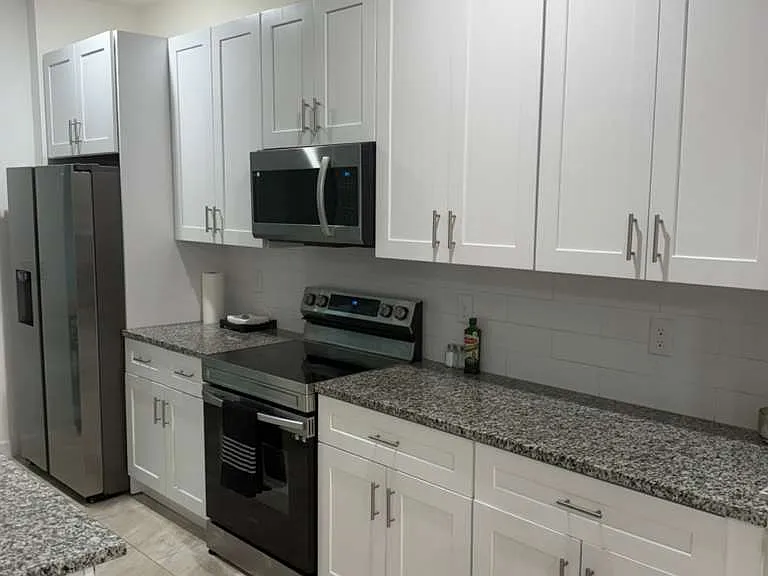 Big kitchen with plates, cutlery set and glasses