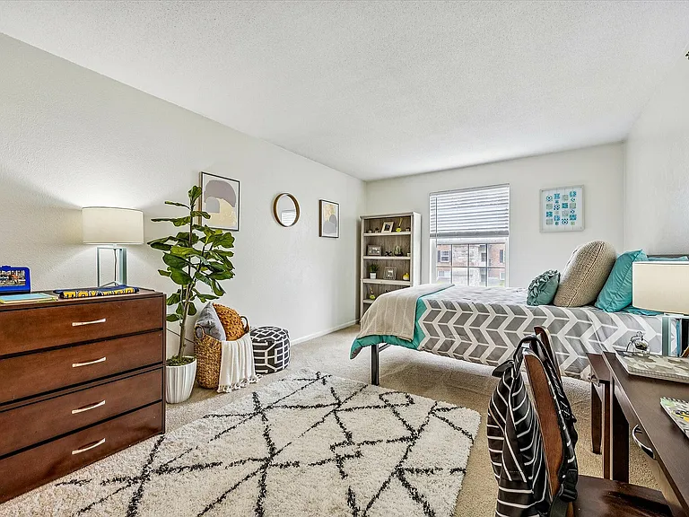 Spacious bedrooms come furnished with a chic dresser, desk and chair and bed.