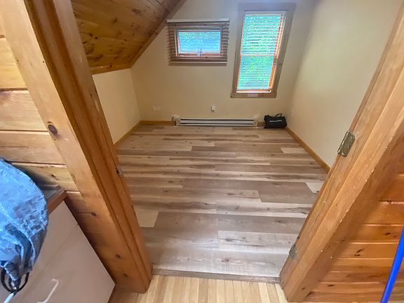 Looking into bedroom with the new flooring which will fit a Queen sized bed