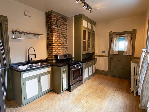 Kitchen - previous colors. New neutral paint, blinds and freshly sanded floor in progress.