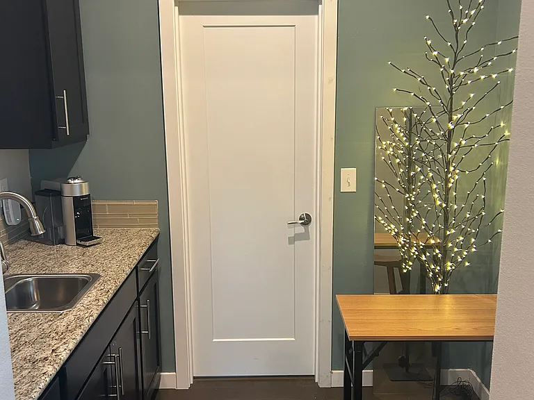 View from shared living room thru kitchenette/pantry with door to private bath