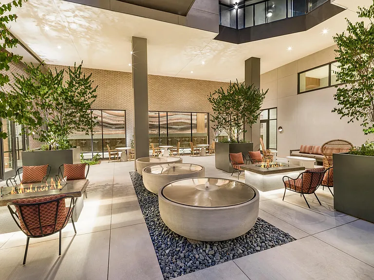 Relax in the serene courtyard with tranquil water features, cozy fire pits, and comfortable seating among lush greenery_ideal for quiet evenings or casual conversations.