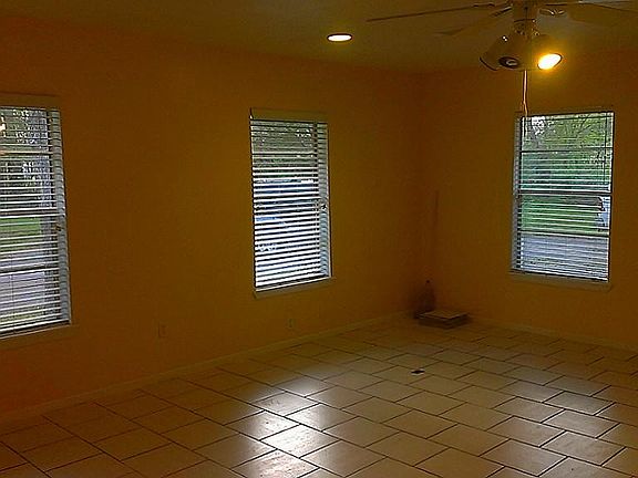 Spacious Den from another angle. Windows from the back yard. Nice 2" blinds.