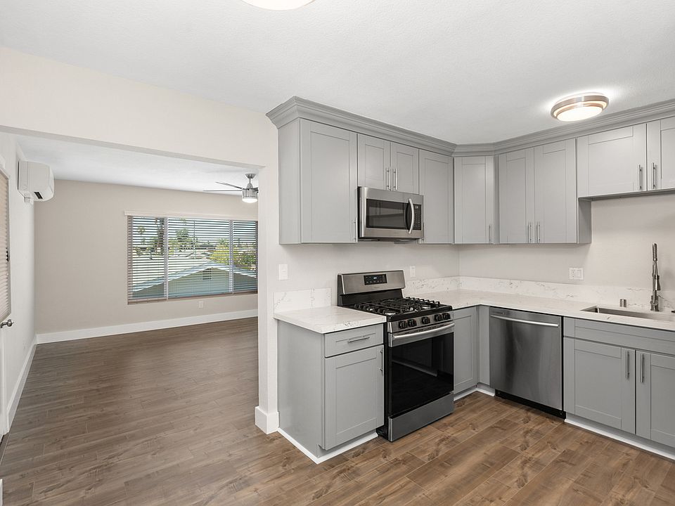 Remodeled with an open-concept feel. Living room, opens to dining room and kitchen.