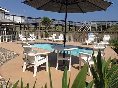 Saltwater pool is shared with guests in other unit of duplex. Pool furniture is labelled for each side.