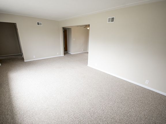 A second view of the living room highlights the newer carpet and paint.  No work needed before you move in and enjoy the space.