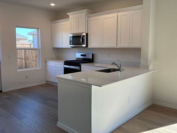 Spacious kitchen with access to backyard some features may vary