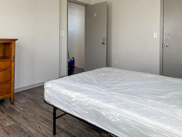 Upstairs bedroom with plenty of natural light and ample closet storage space for personal belongings