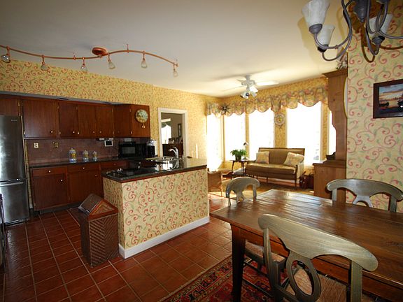 Large country kitchen with family eating area and sunny sitting space.