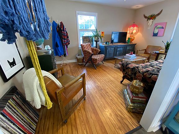 Living room. Preserved original wood floors. Loads of natural light. 2 inch white blinds on all windows.